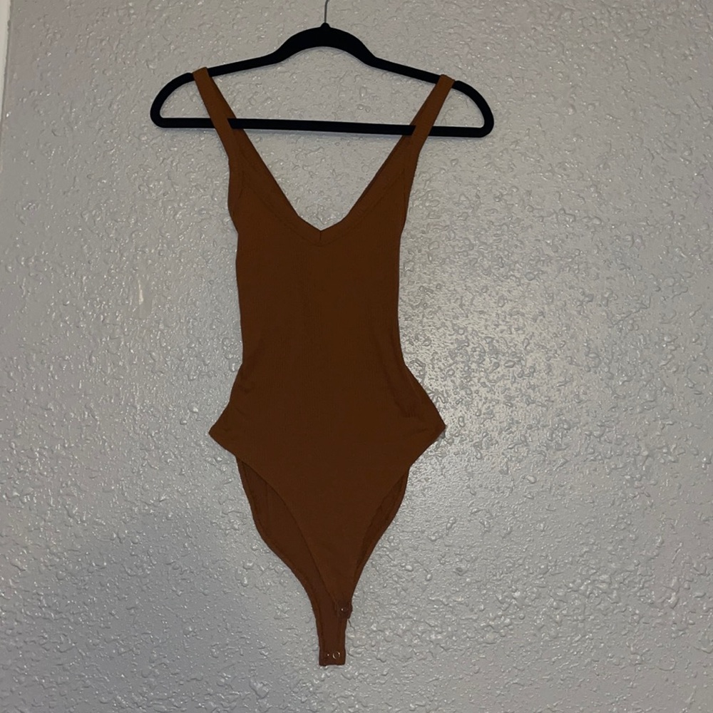 Nude body suit with a crossed back